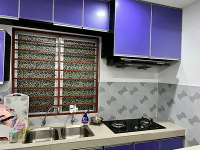 a kitchen with purple cabinets and a sink and a window at Dlaili Homestay in Tanjung Karang