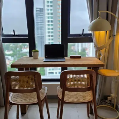 a laptop computer sitting on a wooden table in front of a window at Urban Studio 22Macalisterz- Washer and Nespresso in George Town