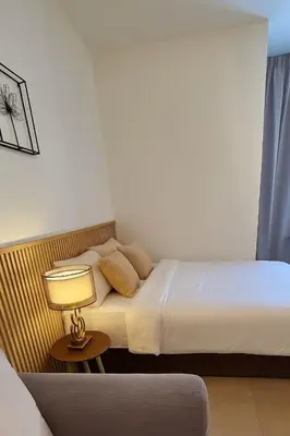 a hotel room with two beds and a lamp at Urban Studio 22Macalisterz- Washer and Nespresso in George Town