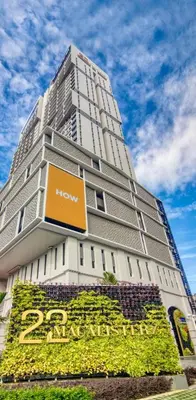 a large building with a sign in front of it at Urban Studio 22Macalisterz- Washer and Nespresso in George Town