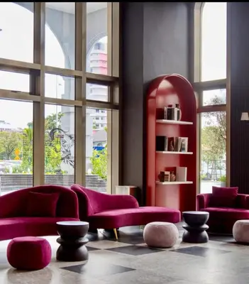 a living room with purple furniture and large windows at Urban Studio 22Macalisterz- Washer and Nespresso in George Town