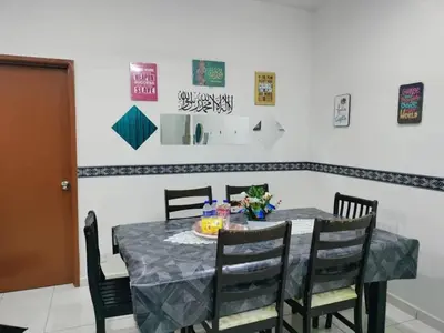 a dining room table with chairs and a plate of food on it at Homestay kita in Gua Sai
