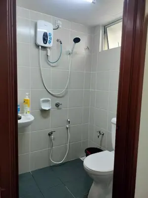 a bathroom with a shower with a toilet and a sink at Homestay kita in Gua Sai
