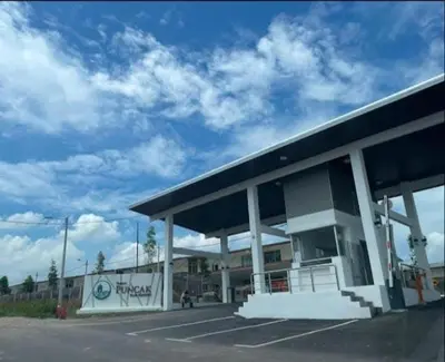 a large gas station with a blue sky at Homestay kita in Gua Sai