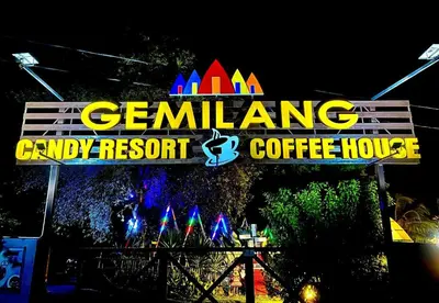 a sign for a community candy resort and coffee house at night at Capital O 91167 Gemilang Candi Resort in Kampong Baru