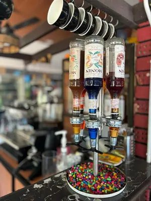 a group of drinks in wine glasses on a counter at Capital O 91167 Gemilang Candi Resort in Kampong Baru