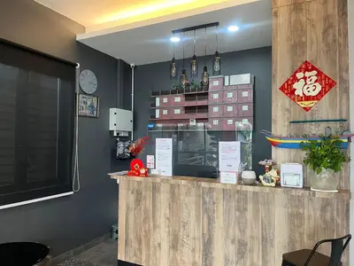 a restaurant with a counter with a window at Capital O 91170 Kurau Bay Hotel in Kuala Kurau