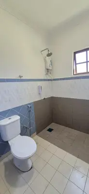 a bathroom with a white toilet in a room at Striatus by Holiday Pool Villa A'Famosa Resort in Gua Sai