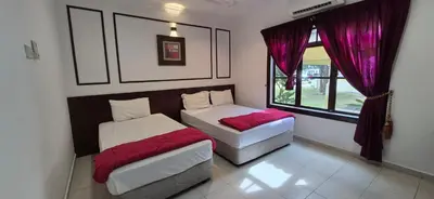 two beds in a room with purple curtains and a window at Striatus by Holiday Pool Villa A'Famosa Resort in Gua Sai