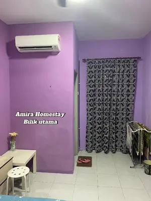 a room with a purple wall with a heater at Amira homestay in Kampong Batu Lima