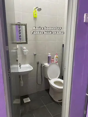a bathroom with a toilet and a sink at Amira homestay in Kampong Batu Lima