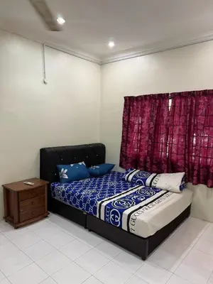a bedroom with a bed and a red curtain at Homestay Maahad Tahfiz Kemukjizatan Al-Quran in Gerik