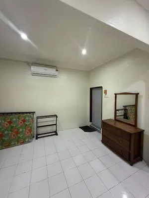 an empty room with a dresser and a mirror at Homestay Maahad Tahfiz Kemukjizatan Al-Quran in Gerik