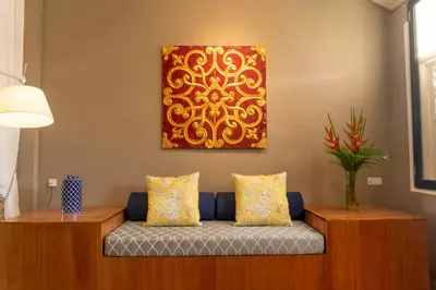 a living room with a couch and a painting on the wall at Argus Residences in George Town