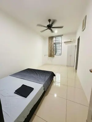 a bedroom with a bed and a ceiling fan at ipoh setia homestay in Ipoh