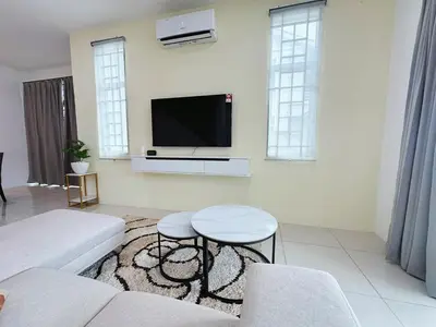 a living room with a couch and a flat screen tv at ipoh setia homestay in Ipoh