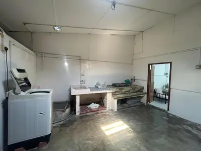 an empty room with a counter and a table in it at Wenya Elegant Homestay \u5927\u4e38\u6587\u96c5\u540d\u5bbf in Pangkor