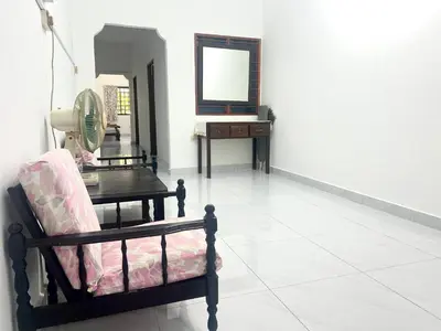 a room with a chair and a table and a mirror at Wenya Elegant Homestay \u5927\u4e38\u6587\u96c5\u540d\u5bbf in Pangkor