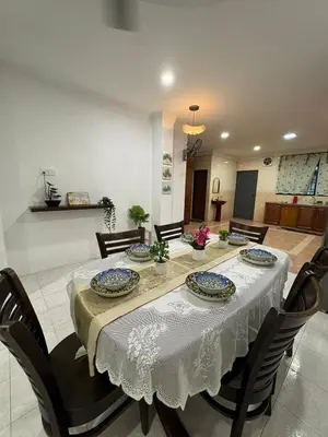a dining room with a table and chairs at Cozy Family Home Seberang Jaya in Kampong Bagan Dalam