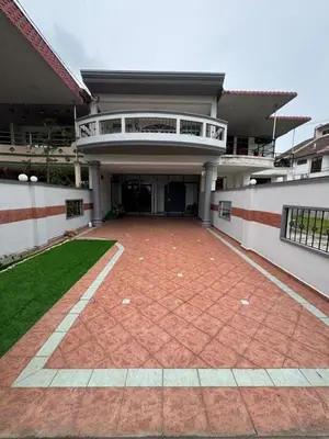 a building with a red brick floor and a balcony at Cozy Family Home Seberang Jaya in Kampong Bagan Dalam