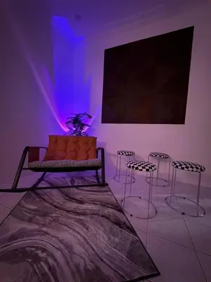 a room with a couch and chairs and a large screen at Cozy Family Home Seberang Jaya in Kampong Bagan Dalam