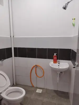 a bathroom with a toilet and a sink at Unit 3 Islam Taqwa Homestay in Kuala Lipis