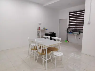 a white table and chairs in a room at Unit 3 Islam Taqwa Homestay in Kuala Lipis