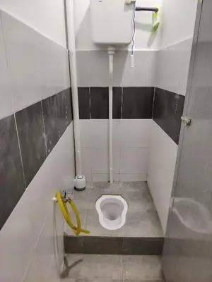 a small bathroom with a toilet in a stall at Unit 3 Islam Taqwa Homestay in Kuala Lipis