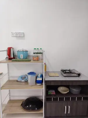 a kitchen with a shelf with some items on it at Unit 3 Islam Taqwa Homestay in Kuala Lipis