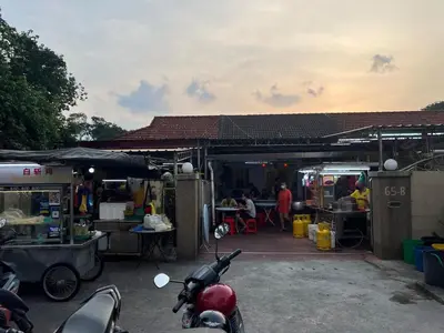 a motor scooter parked in front of a market at Pearl Cottage - 2min Drive to Lam Wah Ee Hospital in George Town