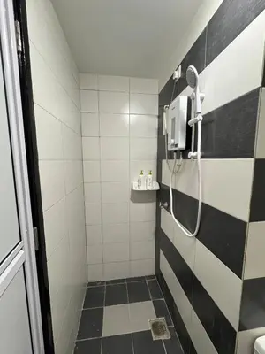 a bathroom with a shower with black and white stripes at Modern Studio The CEO Penang in Bayan Lepas