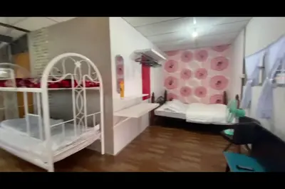 a bedroom with two bunk beds and a pink wall at Galeri Merah Teratak Anak Amas in Sungai Besar