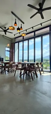 a large room with wooden tables and large windows at Sunya Home Ground Floor Raub Pahang in Raub