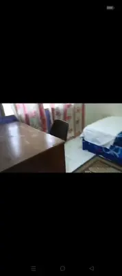 a room with a desk and a bed and a table at Taman Mas Falim in Gua Sai