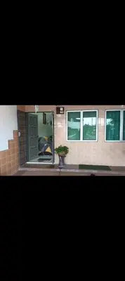 a house with a door and a plant in a window at Taman Mas Falim in Gua Sai