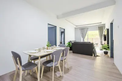 a dining room with a table and chairs at Homestay Emerald Avenue Brinchang Cameron Highlands For 12 Pax Clover Home G23A in Brinchang