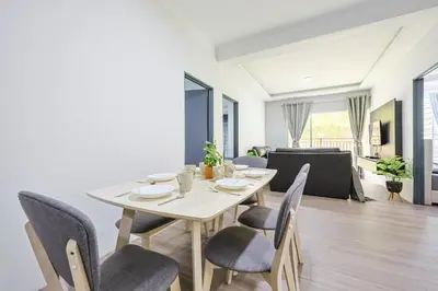 a dining table and chairs in a living room at Homestay Emerald Avenue Brinchang Cameron Highlands For 12 Pax Clover Home G23A in Brinchang