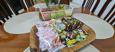 a basket of candy and snacks on a table at Ruma Inn Homestay Perlis in Gua Sai