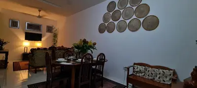a living room with a table and a dining room at Ruma Inn Homestay Perlis in Gua Sai