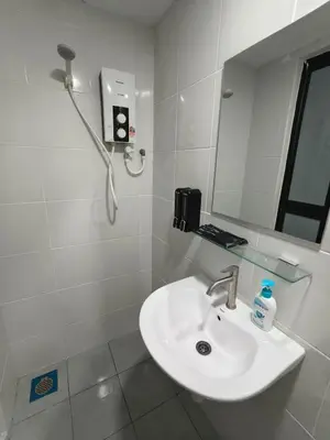 a white bathroom with a sink and a mirror at Unisuites Kampar 5 min UTAR & TARC -1 BR 3pax PetFriendly, 1 Carpark & Netflix I High Floor Unblock Mountain View in Kampar