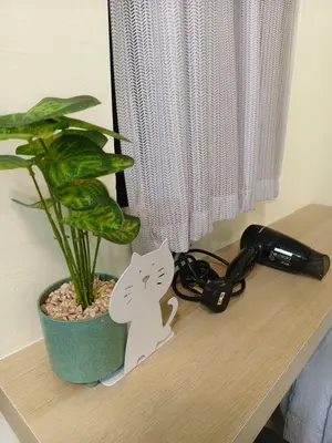 a desk with a cat and a plant on it at Unisuites Kampar 5 min UTAR & TARC -1 BR 3pax PetFriendly, 1 Carpark & Netflix I High Floor Unblock Mountain View in Kampar