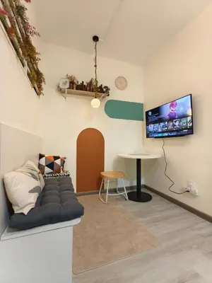 a living room with a couch and a tv on the wall at Unisuites Kampar 5 min UTAR & TARC -1 BR 3pax PetFriendly, 1 Carpark & Netflix I High Floor Unblock Mountain View in Kampar