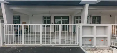 a white fence in front of a house at ZARI Homestay Kamunting in Gua Sai