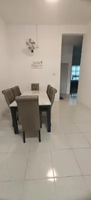 a dining room with a table and chairs at ZARI Homestay Kamunting in Gua Sai