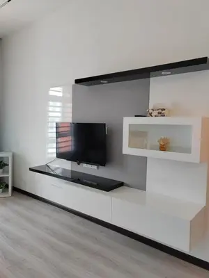 a living room with a tv on a white wall at The Anderson by Triple G Homes in Ipoh