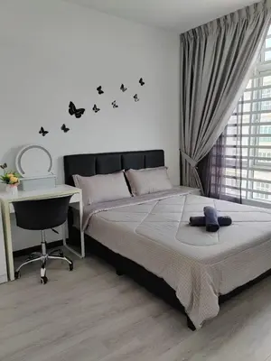 a bedroom with a bed and a desk and a desk at The Anderson by Triple G Homes in Ipoh