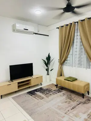 a living room with a tv and a couch at Baitul Mikhael Homestay in Kampong Ayer Melintas Besar