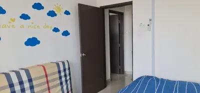 a room with a bed and a wall with blue clouds at Lovely Cocopanther in Gua Sai
