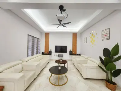 a living room with white furniture and a ceiling fan at Ipoh town7br5bath 25 pax pool table mahjong karaok in Ipoh