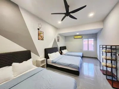 a bedroom with two beds and a ceiling fan at Ipoh town7br5bath 25 pax pool table mahjong karaok in Ipoh